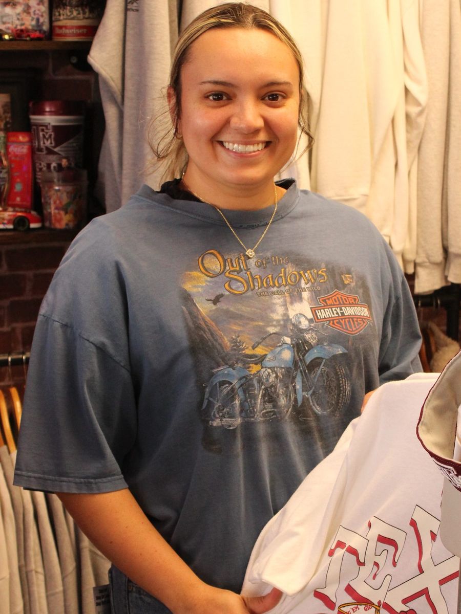 Shopper smiling in a faded Harley-Davidson graphic tee